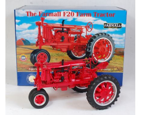 A Franklin Mint 1:12 scale model of a Farmall F20 tractor comprising red body with red and silver spoked hubs, in the origina