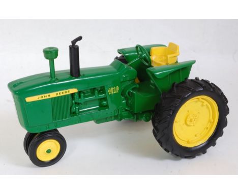 A Danbury Mint 1:16 scale model of a John Deere 4010 diesel tractor, fitted with a working clock to rear tyre, loose example