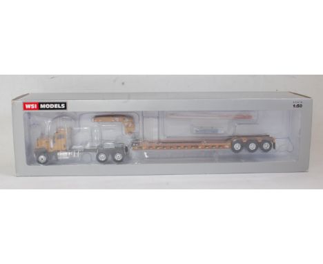 A WSI Models No. 39-1008 1:50 scale model of a CT680 6x4 Caterpillar tractor unit with Roger Low Boy 3 axle trailer, WSI USA 