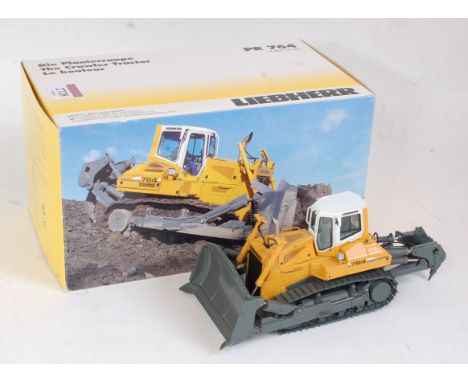 An NZG No. 775 1:50 scale model of a Liebherr PR764 crawler tractor comprising of orange, white and grey body with grey track