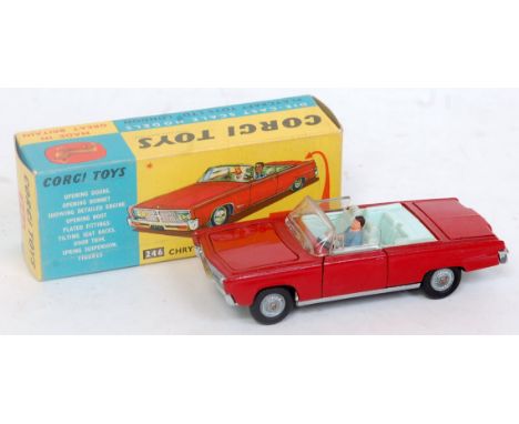 A Corgi Toys No. 246 Chrysler Imperial comprising red body with light blue interior and two figures, with golf trolley in boo