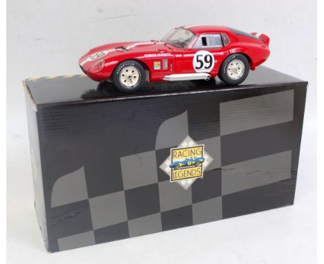 An Exoto No. 18004 1:18 scale model of a 1965 Cobra Daytona, finished in red with racing No. 59 and white bonnet stripe, all 