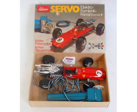 A Schuco No. 5312 diecast and tinplate model of a Ferrari F2 racing car, comprising red body with grey and chrome engine and 
