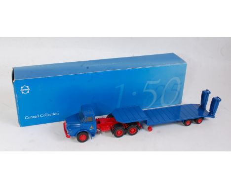 A Conrad No. 1045/0 1:50 scale model of a Man DHAS 26.240 6x2 tractor unit with twin axle low loader trailer finished in blue