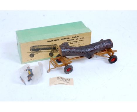 A Britains Model Farm No. 129F timber trailer with rubber tyres comprising of brown body with red hubs, with log load, and fa