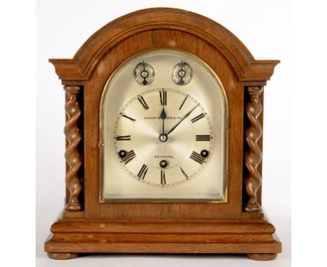 A GERMAN OAK MANTLE CLOCK WITH THREE TRAIN MOVEMENT, THE SILVERED DIAL INSCRIBED A MASON WILLIAMS AND CO BRIDGEND, IN BREAKAR