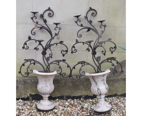 A pair of six light candle holders, in the form of urns with foliage, 115 cm high 