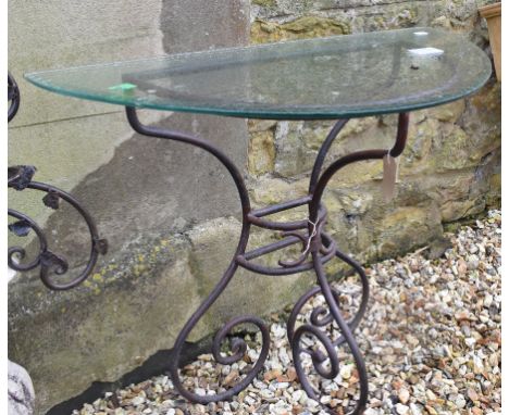A wrought iron console table, with a glass top, 89 cm wide 
