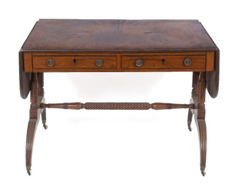 An early 19th century mahogany sofa table, crossbanded, having two real and two false drawers, on roped twist legs joined by 