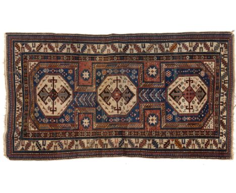 An Eastern rug, decorated geometric motifs on a light blue ground, within a multi border, 204 x 115 cm See inside back cover 