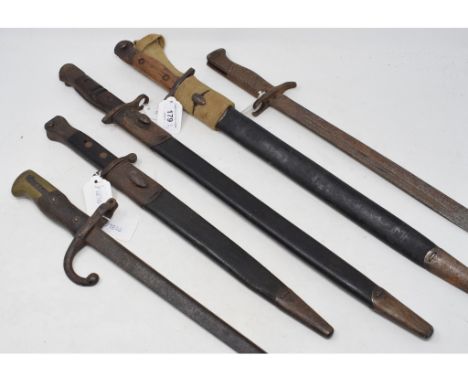 A Remington bayonet, 1930, with a scabbard, a Lithgow bayonet and scabbard, another bayonet and scabbard, and two other bayon