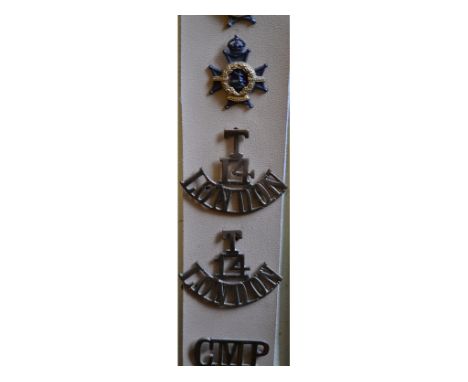 Twenty seven various cap, collar and shoulder titles, including T14 London (pair), Notts and Derby Reg (silver and enamel), C