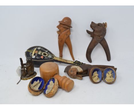 Three pairs of novelty treen nut crackers, a 19th century novelty inkwell, in the form of a dancing bear, 7.5 cm high, and ot