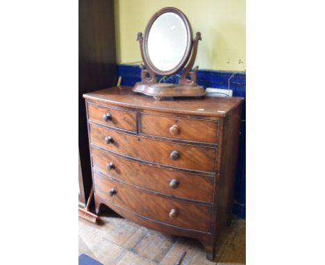 A Victorian mahogany bow front chest, of two short and three long drawers, on bracket feet, and a toilet mirror (2) 