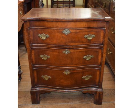 An early 18th century style serpentine front chest, veneered in walnut, having three graduated long drawers, on bracket feet,