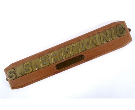 A ship's lifeboat nameplate, S.S. Britannic, drilled and mounted on a wooden plaque, with a smaller plaque below 'Sunk in the
