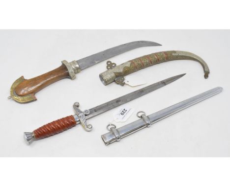 A German Third Reich Luftwaffe dagger, and scabbard, probably of post war manufacture, and a jambaiya, with a brass and coppe