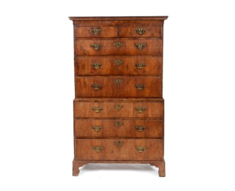 A tallboy chest on chest, veneered in walnut, having two short and three graduated long drawers, above a  three further gradu