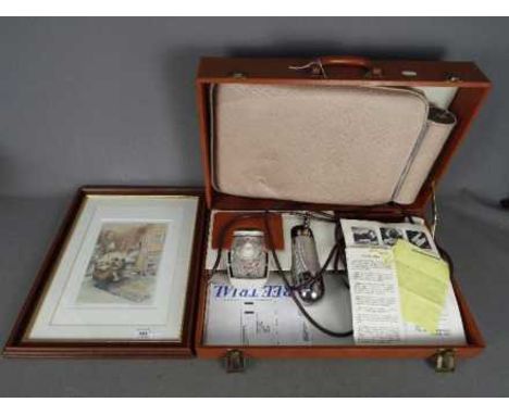 A vintage Niagara Cyclo Massage kit comprising hand unit and seat pad, contained in carry case and a limited edition print af