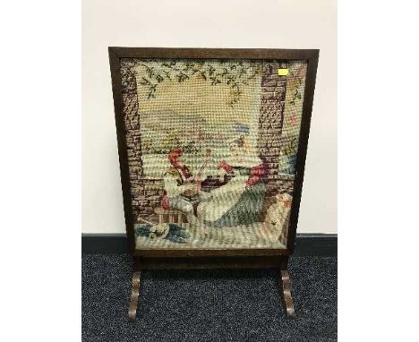 A tapestry fire screen and small folding table 