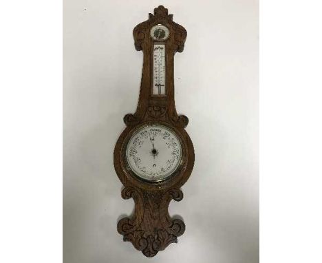 A carved oak barometer 