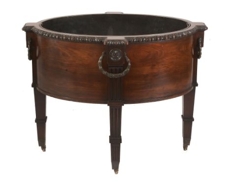 A George III mahogany and patinated metal mounted oval wine cooler, circa 1775, with gadroon carved rim and outset terminals 