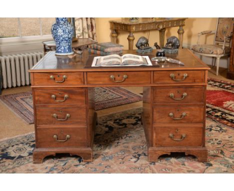 A George III mahogany twin-pedestal partner s desk , circa 1800, the gilt tooled leather inset top with moulded edge above an