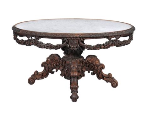  A Victorian carved walnut and marble mounted centre table,   circa 18 60, the oval grey veined white marble top within a rep