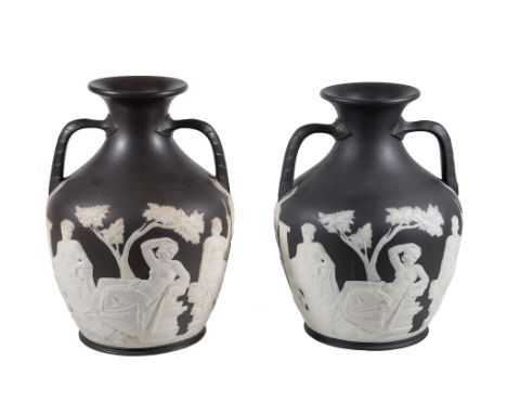  Two Wedgwood black basalt copies of the Portland or Barberini vase  ,  late 19th century, typically sprigged in white with c