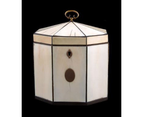 Ω A George III ivory veneered and ebony strung tea caddy, circa 1800, of octagonal section, the hinged pyramidal cover with g