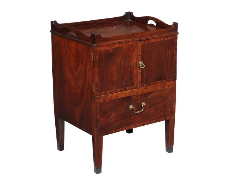 A George III mahogany and crossbanded night commode,   circa 1790, the shaped gallery incorporating a pair of pierced handle