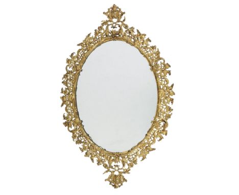 A gilt metal wall mirror,   mid 19th century, the oval plate with a pierced frame cast with leafy vines and trellis border f