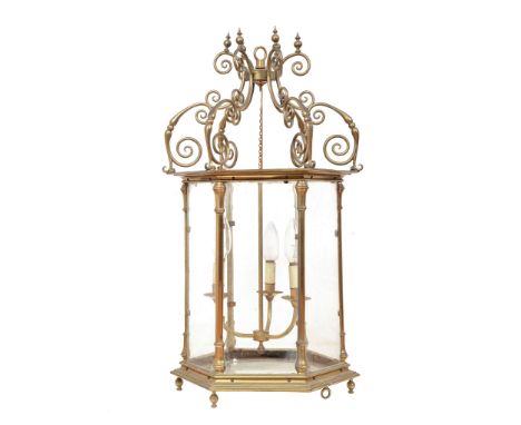  A late George III brass and glazed hall lantern,   early 19th century, of hexagonal section, the six supports modeled as con