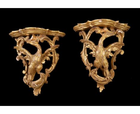 A pair of George III carved giltwood wall brackets , circa 1770, each shaped shelf above the Ho-Ho bird, flanked by C scroll 