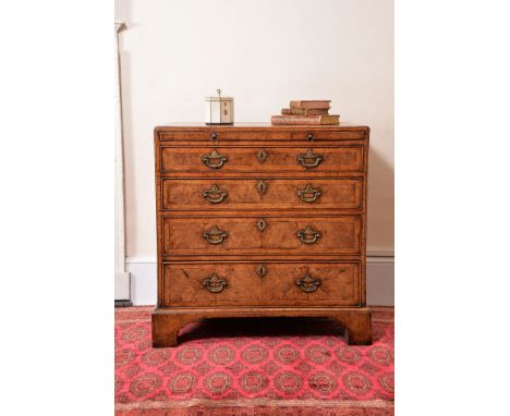 A George II walnut and featherbanded chest of drawers, circa 1740, attributed to Giles Grendey, the rectangular caddy moulded