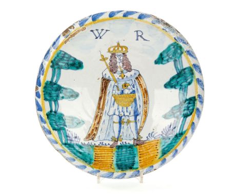  A London delft royal portrait blue-dash charger,   circa 1690, painted with the crowned standing figure of King William III 