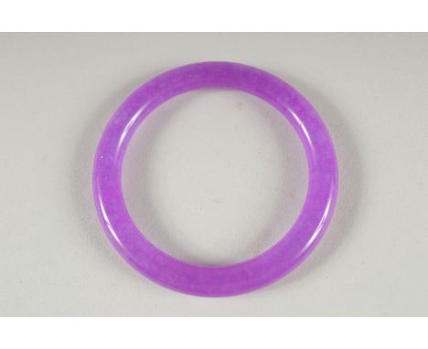 A LAVENDER JADE BANGLE. 3ins diameter.