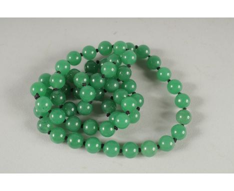 A STRING OF JADE BEADS.  26ins long.