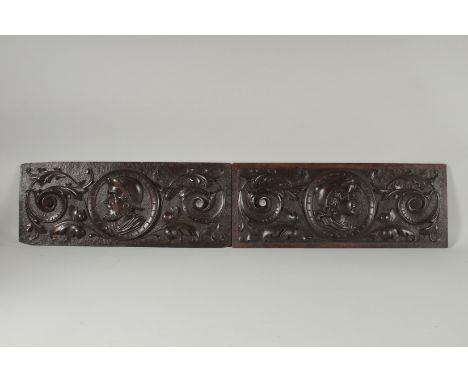 A GOOD PAIR OF OAK CARVED PANELS with portrait roundels and scrolls. 19ins x 7ins.