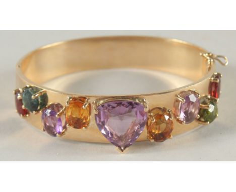 A SUPERB 18CT GOLD BANGLE set with precious stones.