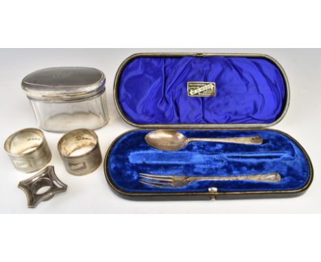 Hallmarked silver spoon, fork, two napkin rings and candlestick sconce, together with a hallmarked silver lidded glass dressi