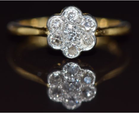 An 18ct gold ring set with a cluster of diamonds in a platinum setting, 3.6g, size N