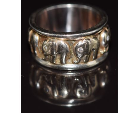A 14ct gold ring embossed with eight elephants each set with a diamond eye, 8.9g, size K
