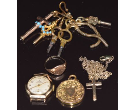 A 9ct gold chain, 9ct gold cross, 9ct gold signet ring (4.7g), 9ct gold back &amp; front locket with scrolling and shield dec