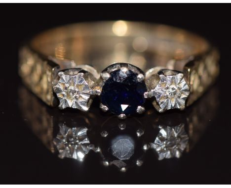 A 9ct gold ring set with a sapphire and diamonds, with textured shoulders, 3.5g, size P