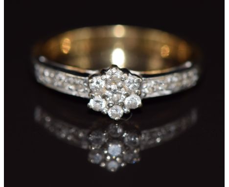 An 18ct gold ring set with diamonds in a cluster, 3.4g, size K