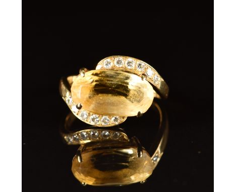 An 18ct gold set with an oval cut citrine and diamonds in a twist setting, 3.8g, size K