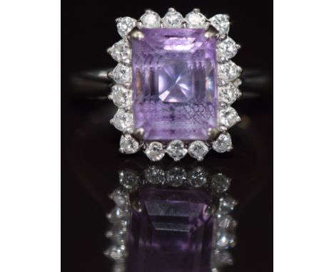 An 18ct white gold ring set with an emerald cut amethyst surrounded by diamonds, 3.9g, size M