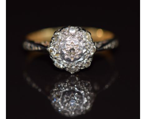 An 18ct gold ring set with diamonds in a platinum cluster setting, 2.7g, size K