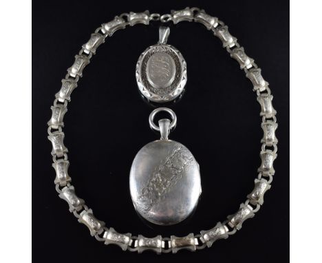 Two Victorian silver lockets with engraved decoration and a Victorian white metal chain&nbsp;